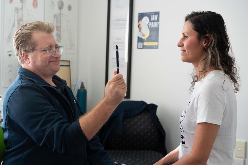 Clinician conducting eye test with patient