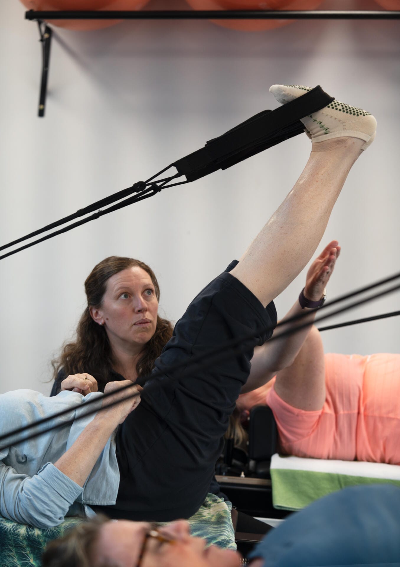 Woman performing leg stretch with resistance straps