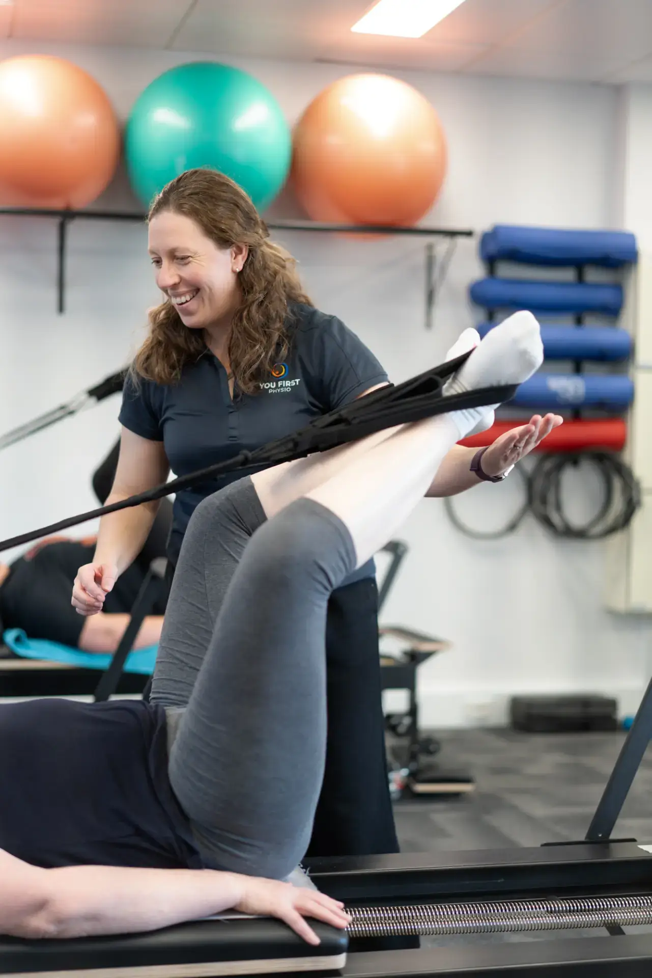 Physical therapist assisting patient with resistance band exercise